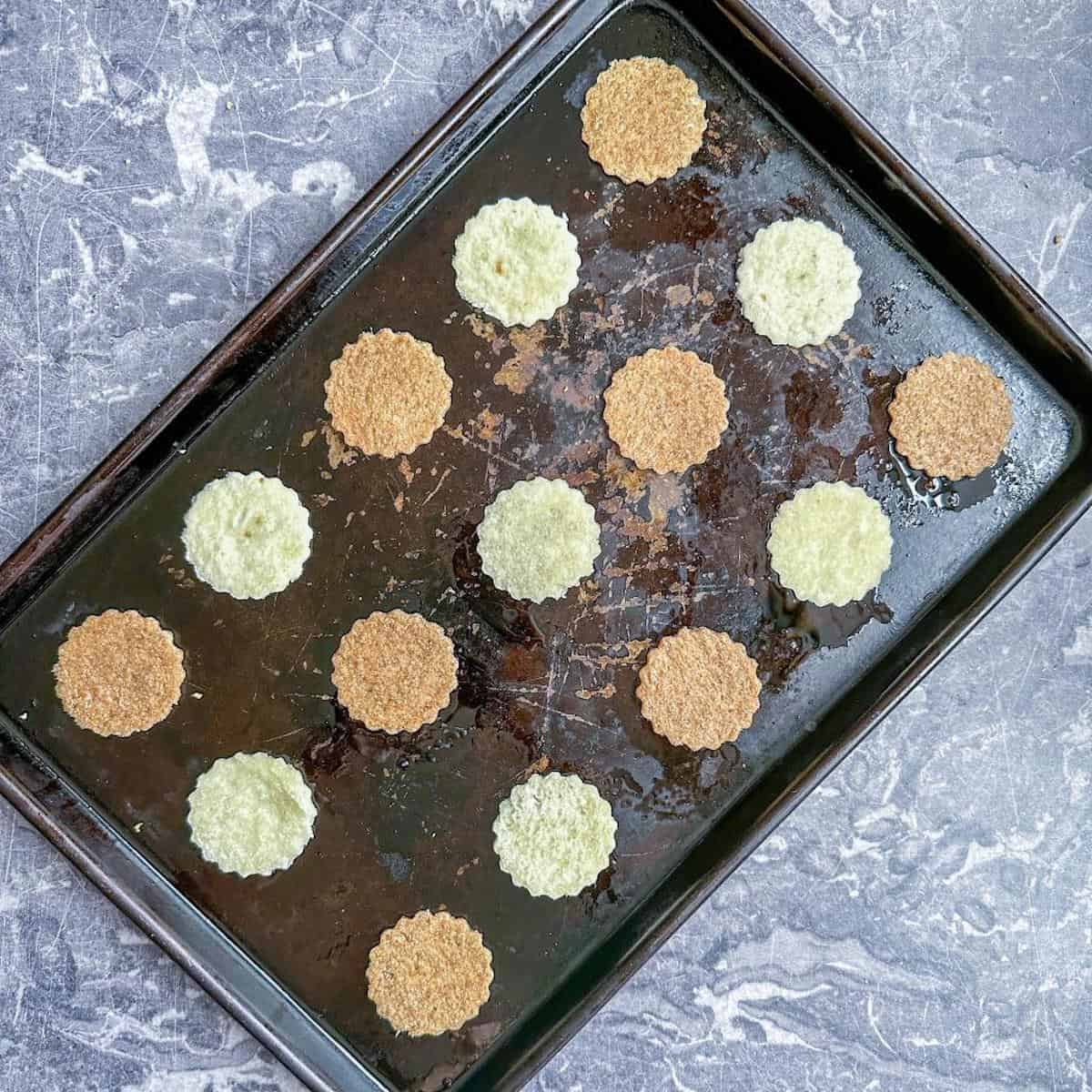 An oven tray covered with bread canape bases. 