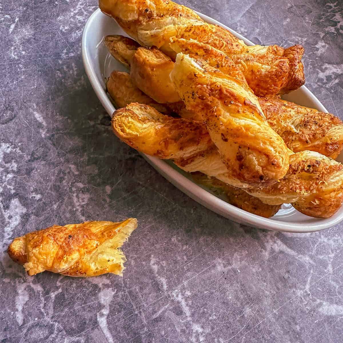 A serving of parmesan cheese twists in a bowl. 