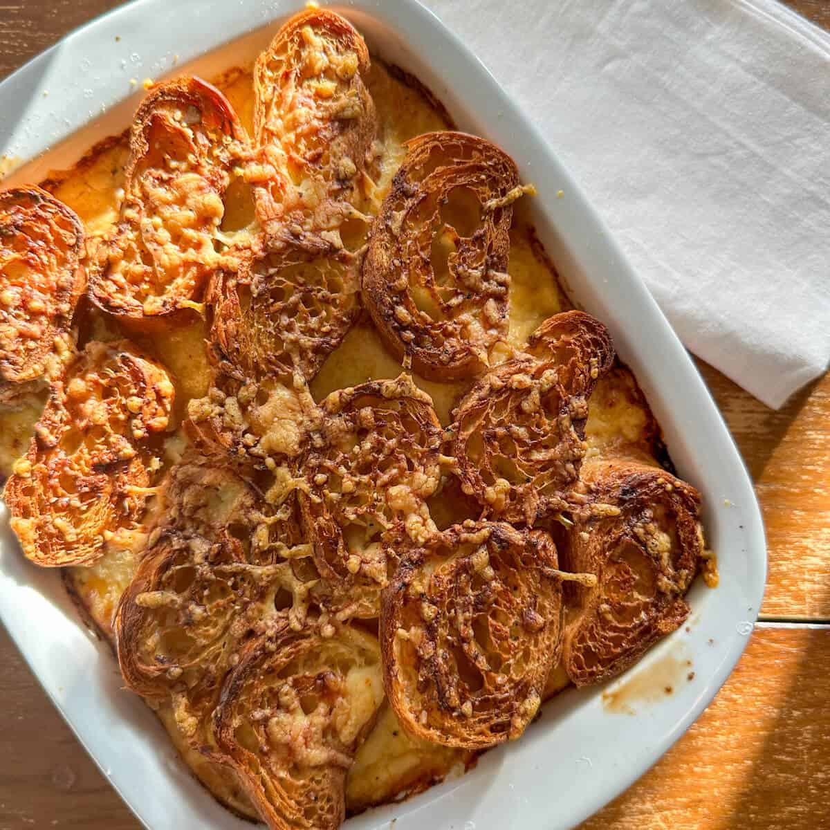Ham and Cheese Savory Croissant Bread Pudding in a serving dish.