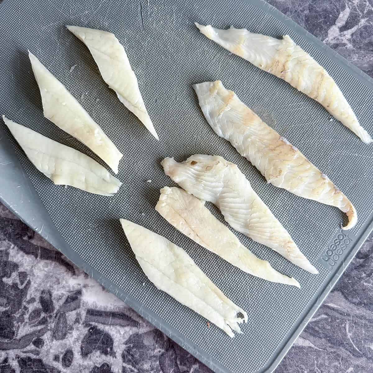 Fish fillets cut into strips, ready to panne and turn into fish goujons. 