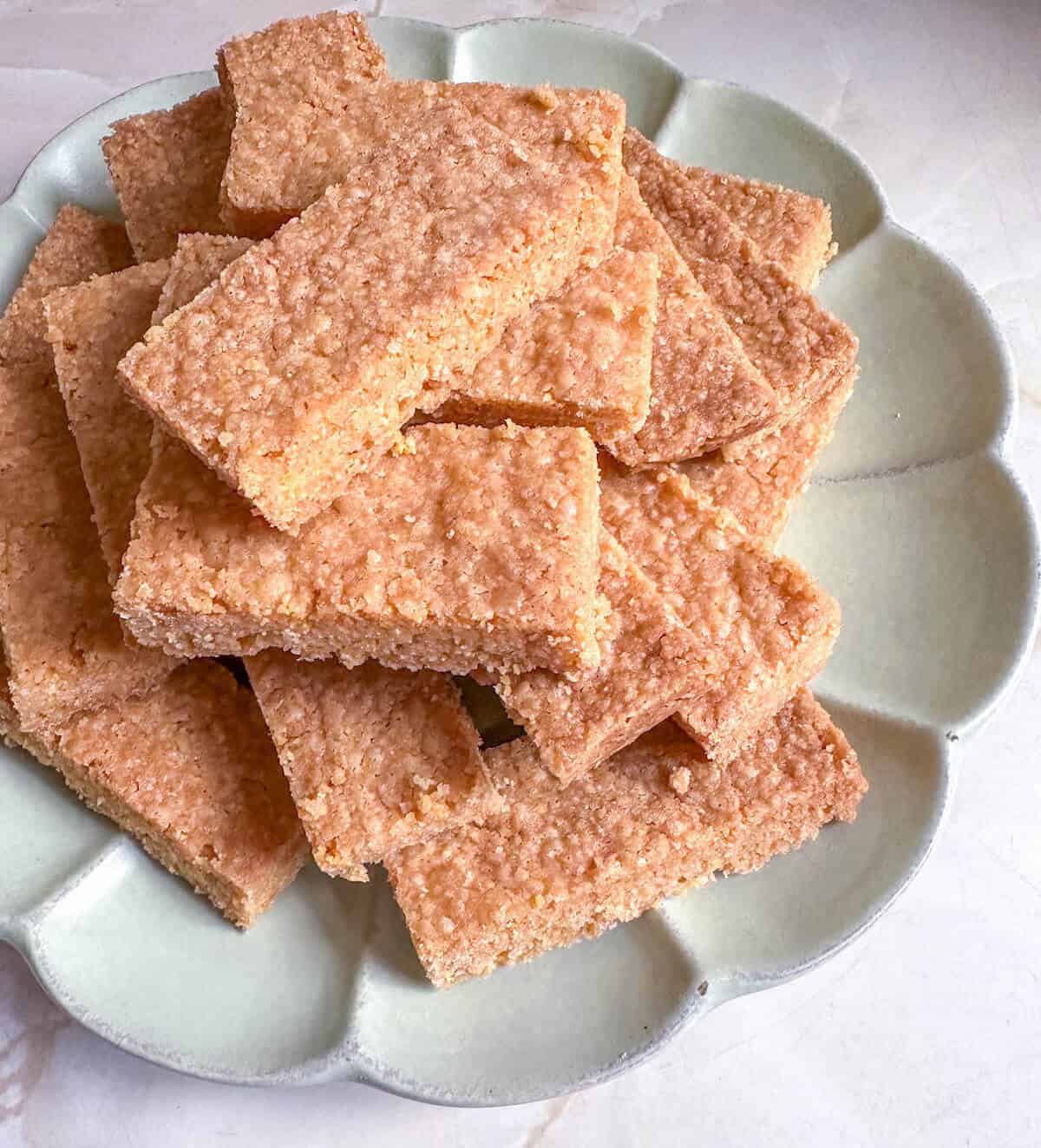 A pile of polenta shortbread cookie bars on a plate. 