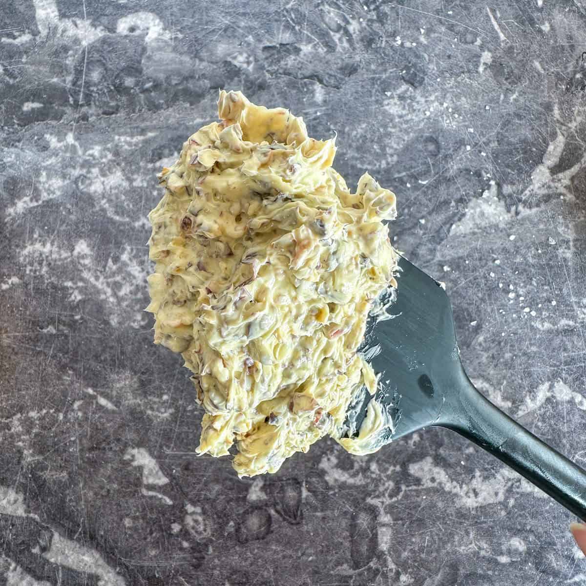 A spatula with seaweed butter on it. 