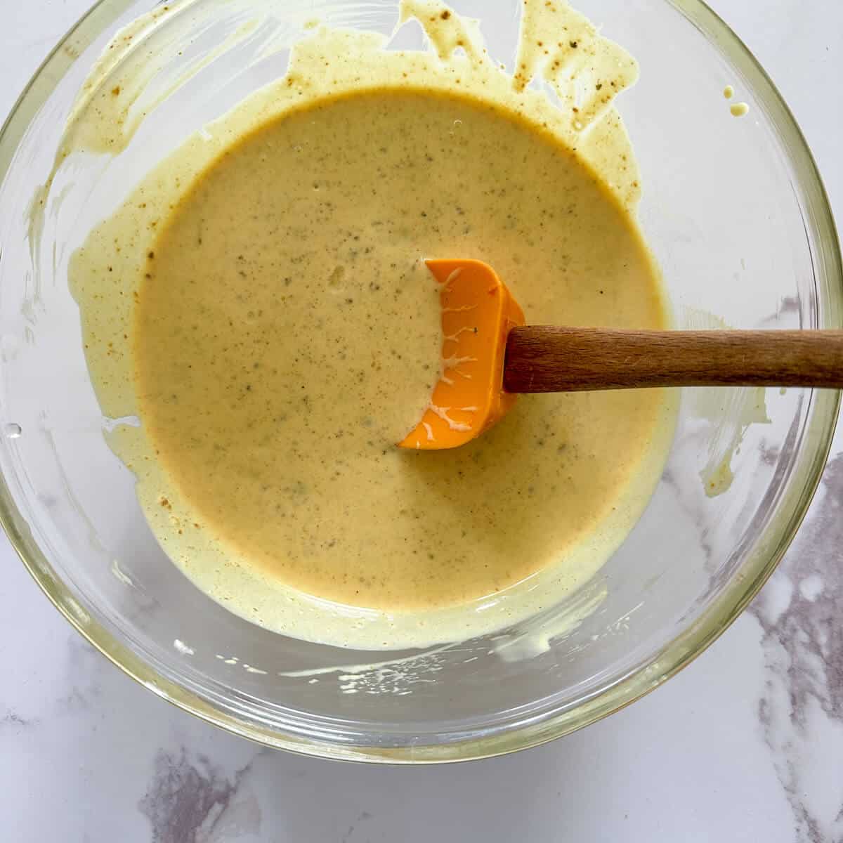 Coronation sauce in a mixing bowl. 