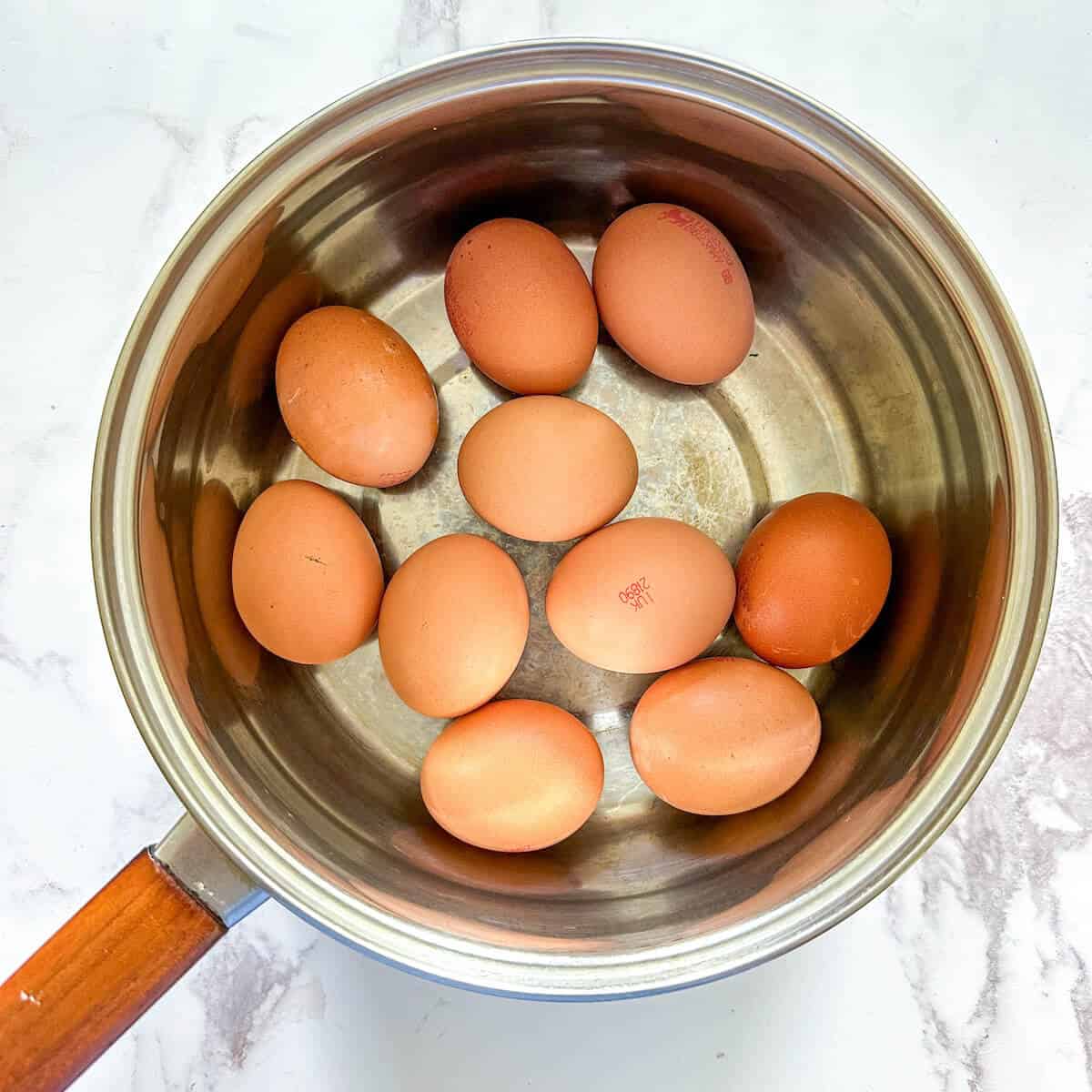 A large saucepan full of eggs ready to be boiled. 