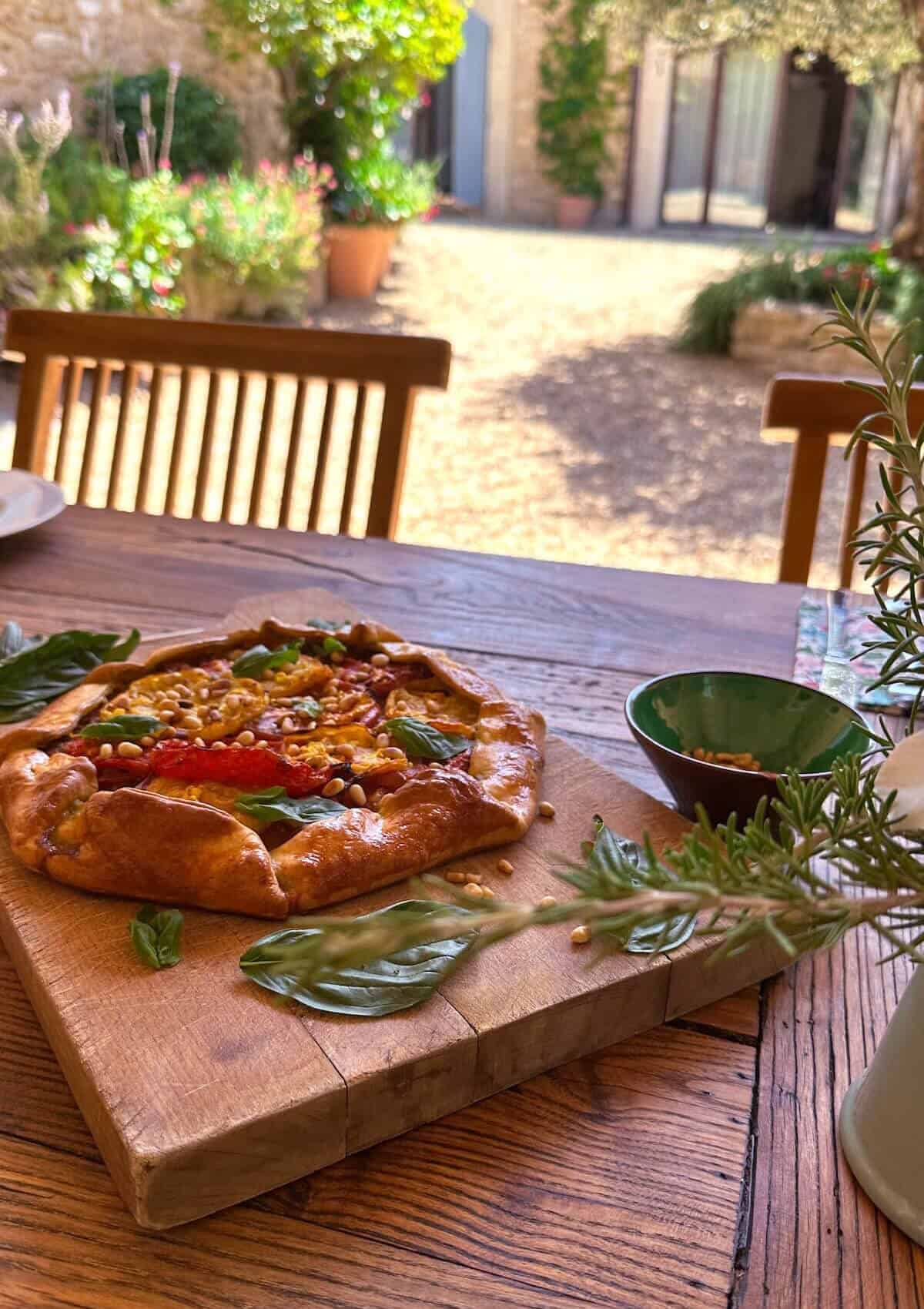 A tomato galette on a wooden table in Provence.