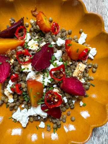 Roasted beetroot and feta salad with balsamic hot honey dressing on a bed of puy lentils.