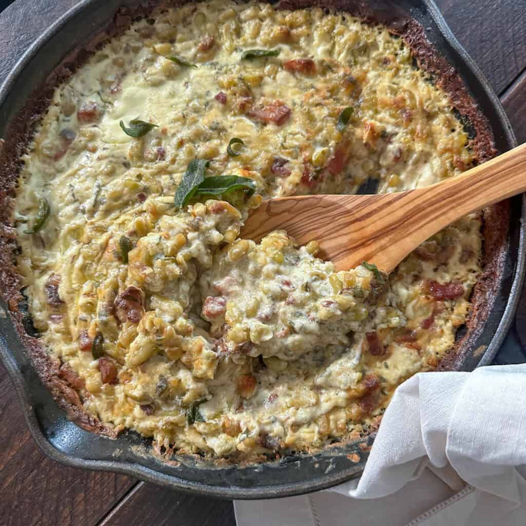 Creamy flageolet beans in a cast iron skillet.