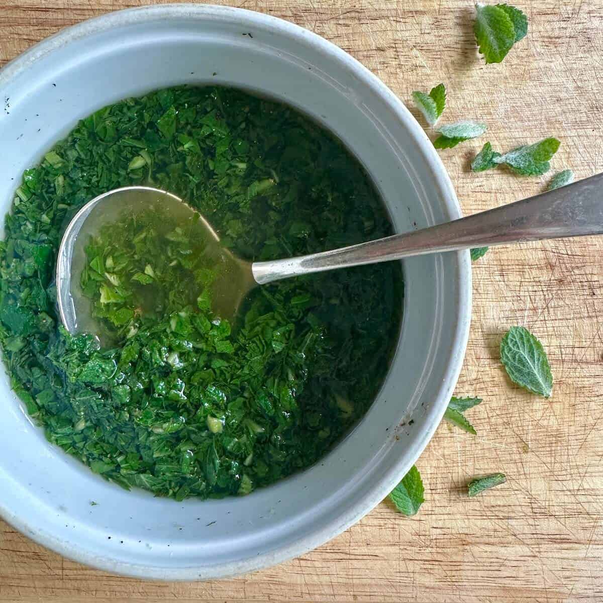 A bowl of mint sauce. 