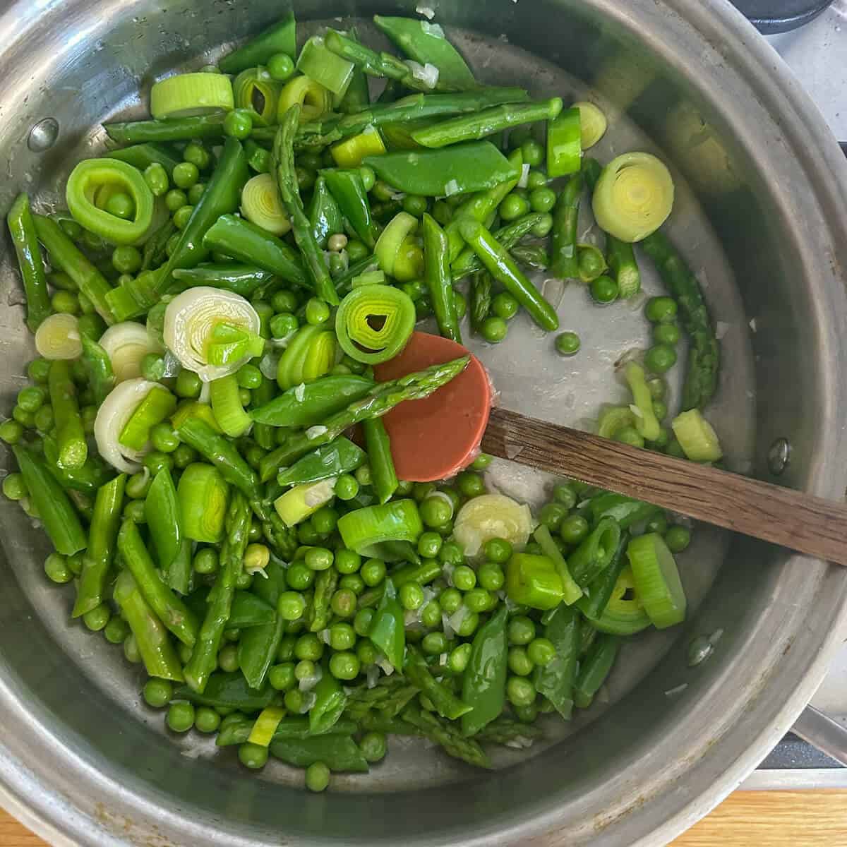 Spring green vegetables in a frying pan. 