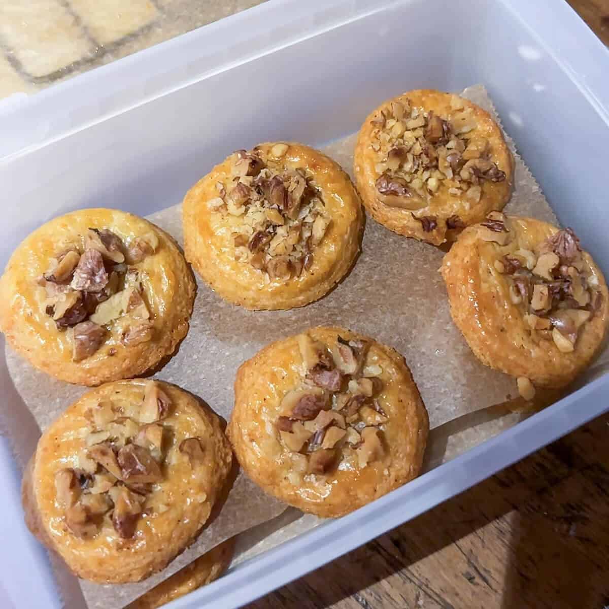 Walnut and parmesan sables in a Tupperware container. 