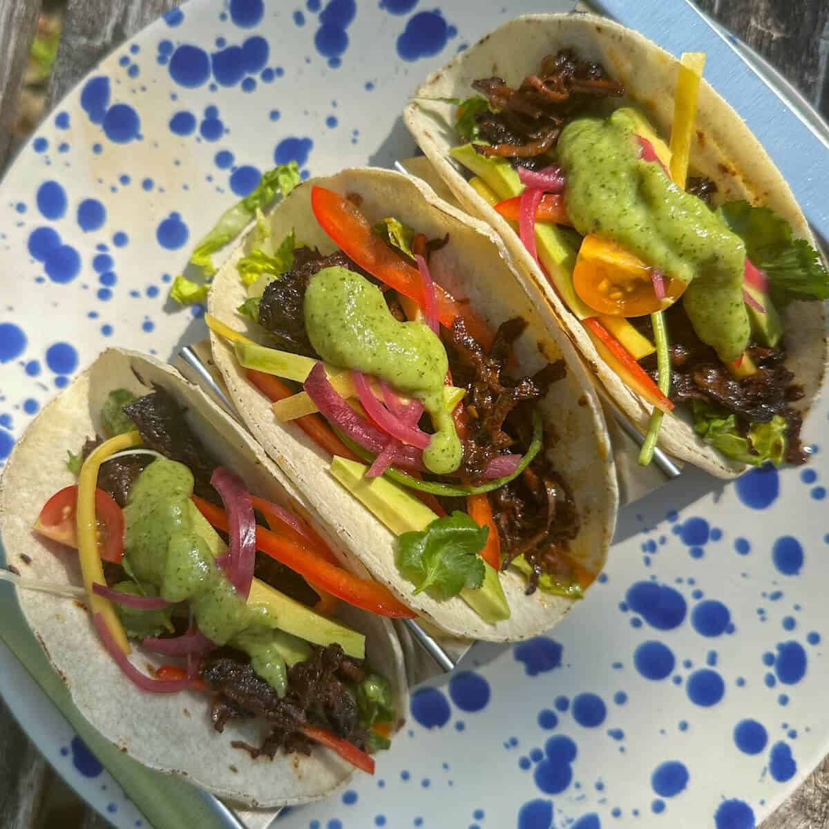 Tacos with spicy lime avocado sauce on them. 