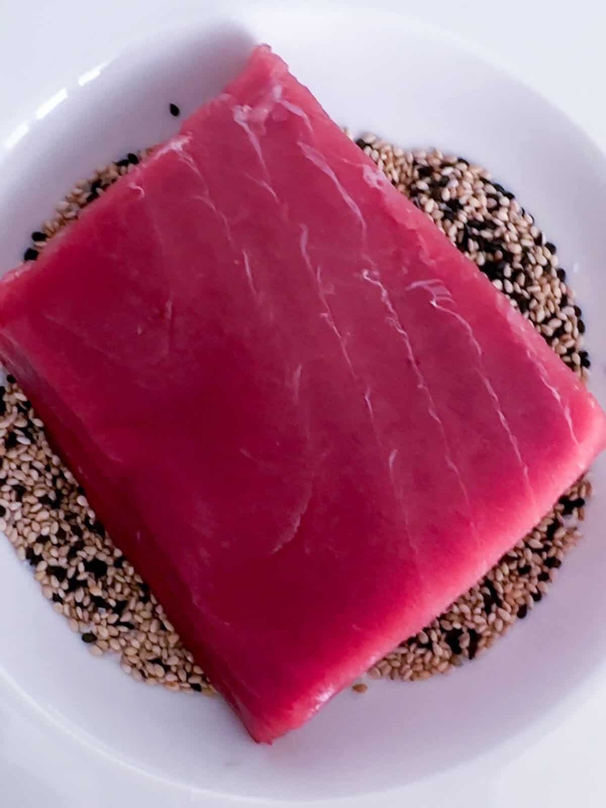 Bluefin tuna Akami in a bowl of sesame seeds. 
