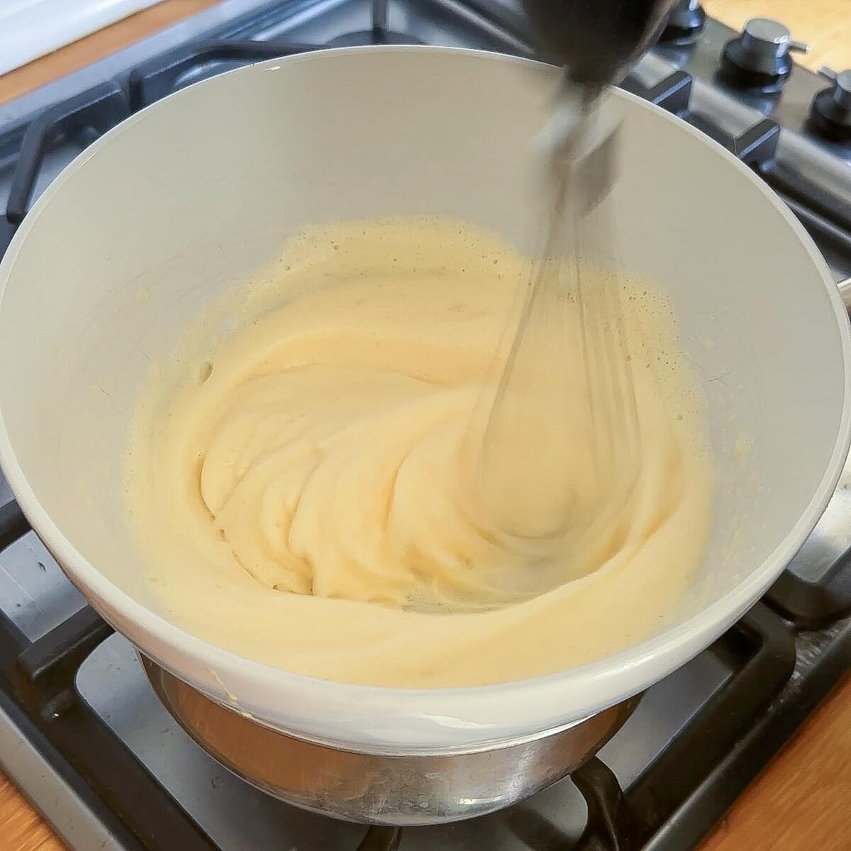 Egg being whisked over a double boiler.