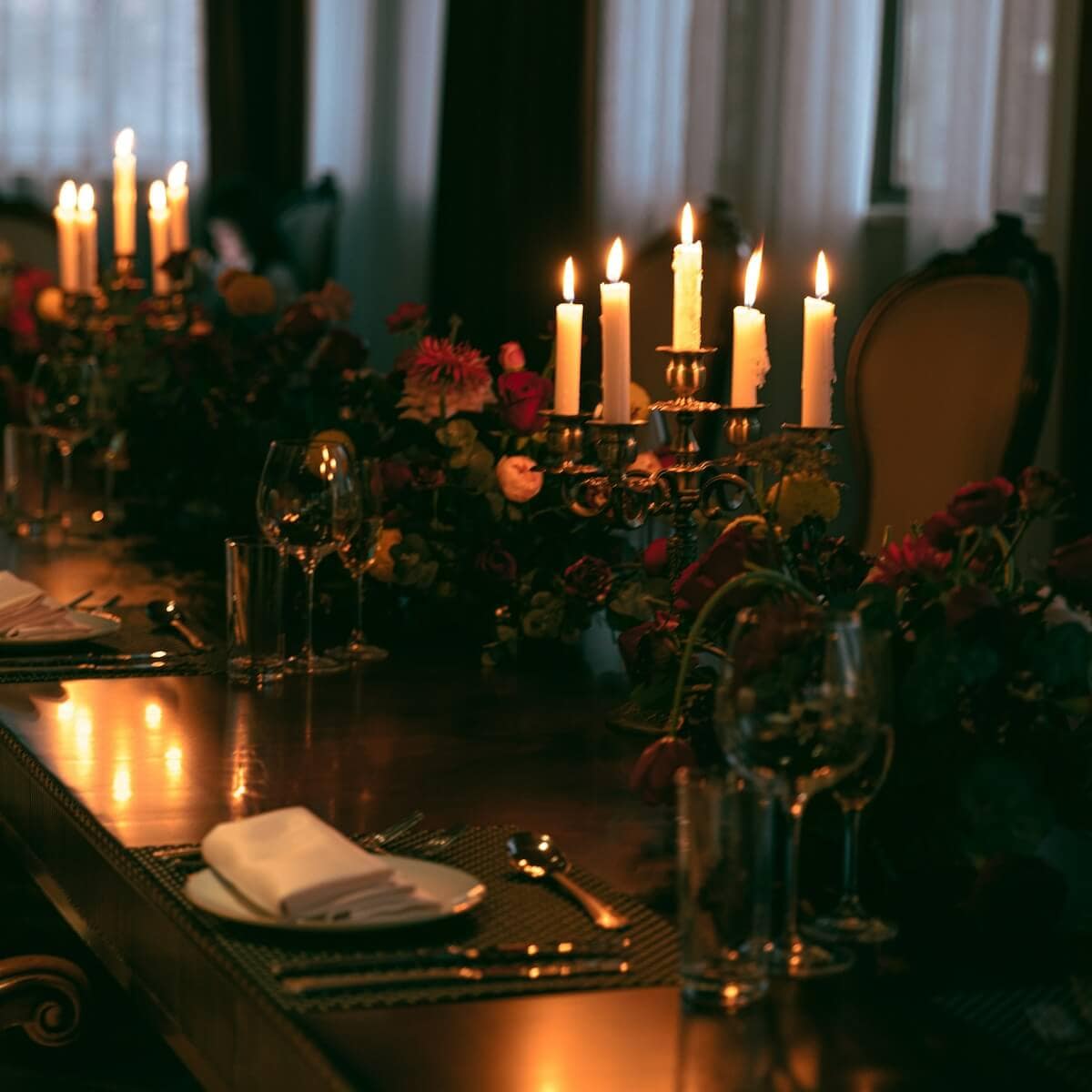A romantic yet formal dinner table with candles.