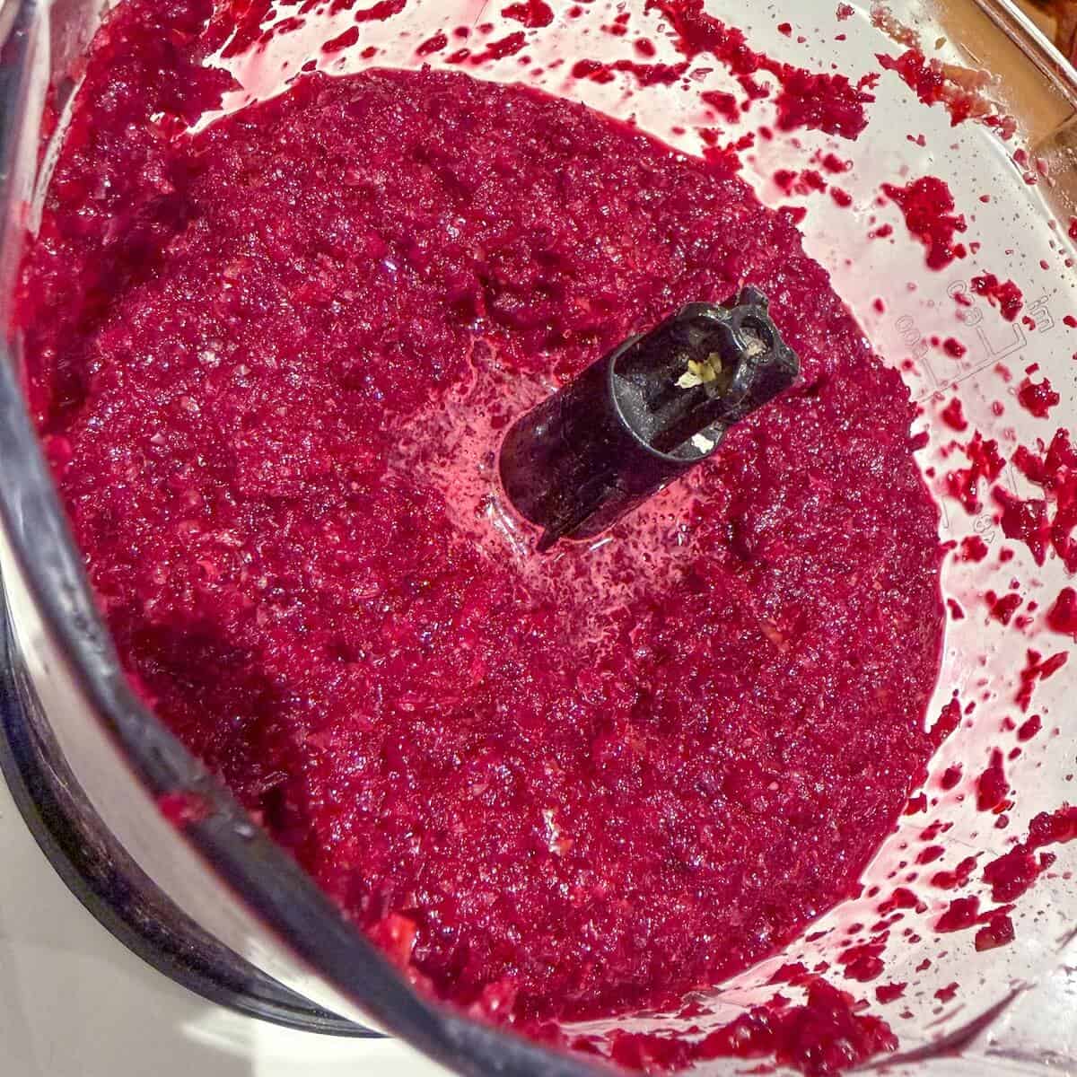 A food processor containing the beetroot cure mix for gravadlax.
