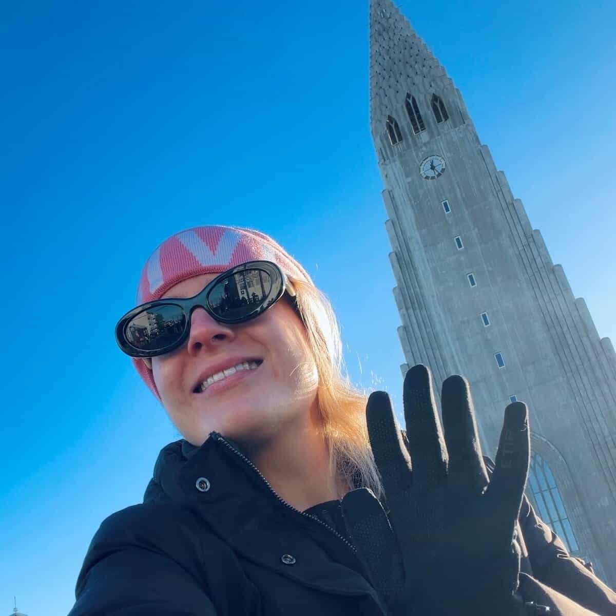 Rosanna in Iceland, standing in front of the famous Reykjavík cathedral.