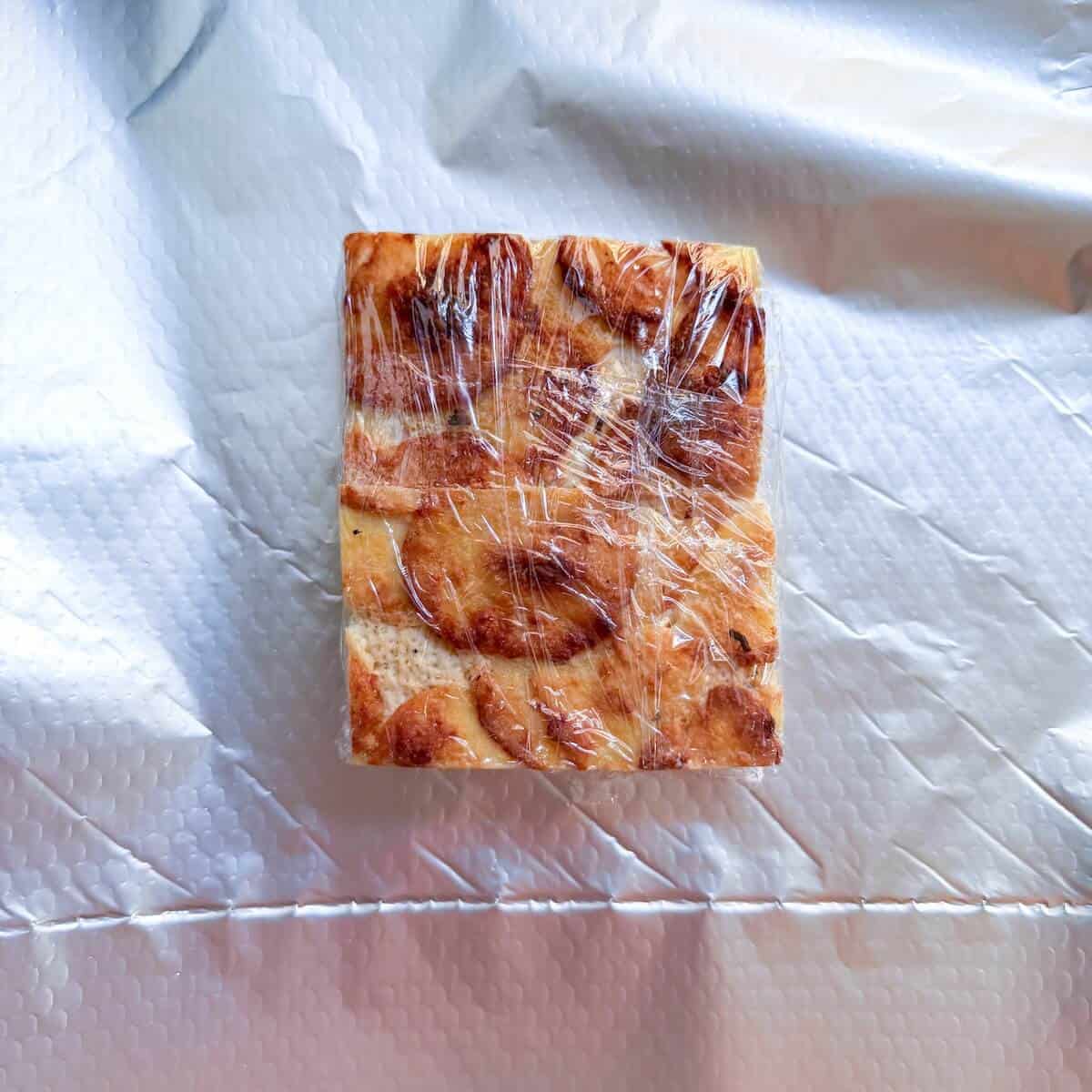 A slice of dauphinoise potatoes wrapped up and ready to freeze.