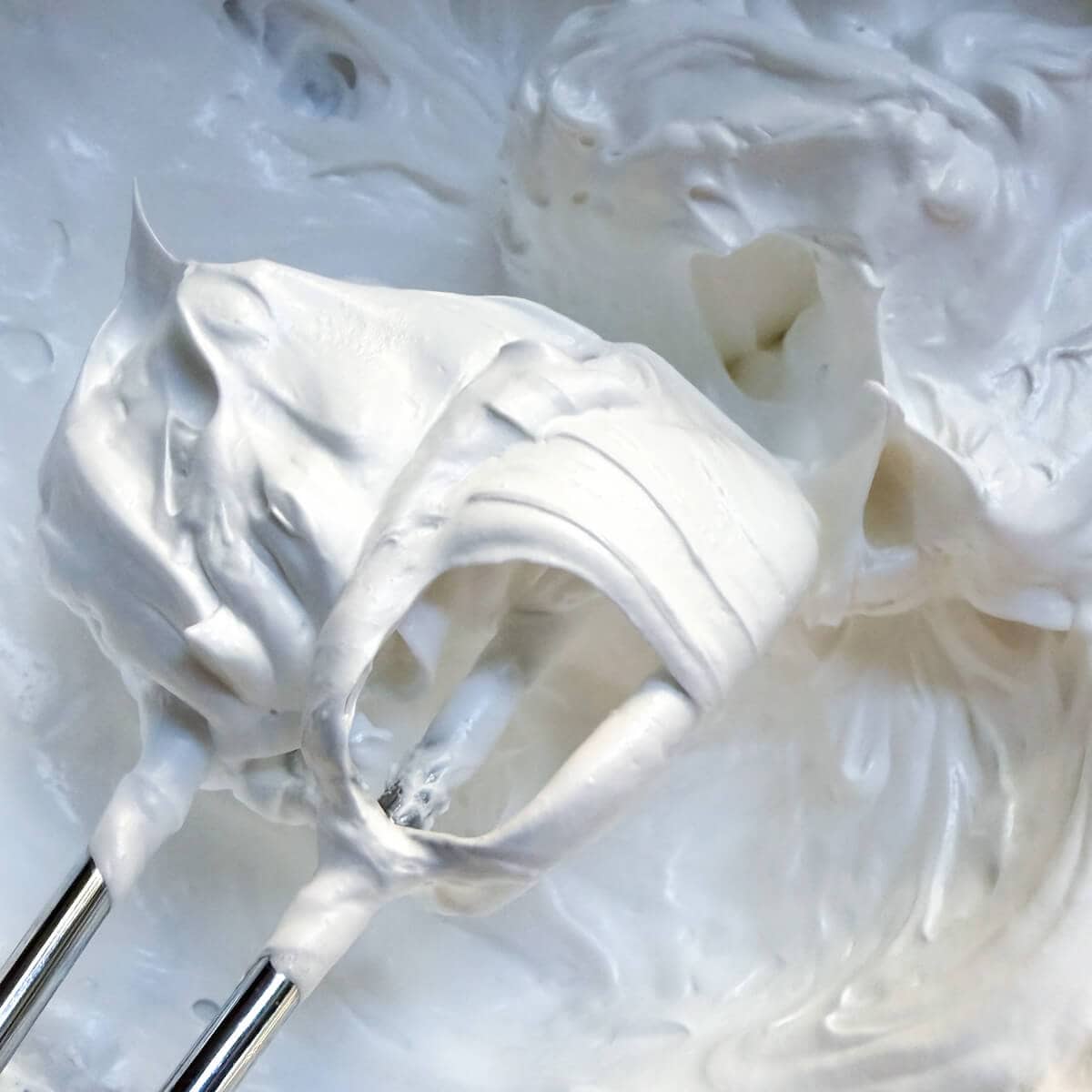 Whipped egg whites showing stiff peaks.