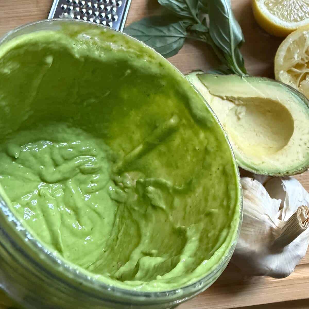 An image to show the best consistency of the basil avocado dressing. It is still thick and gloopy, and not runny.